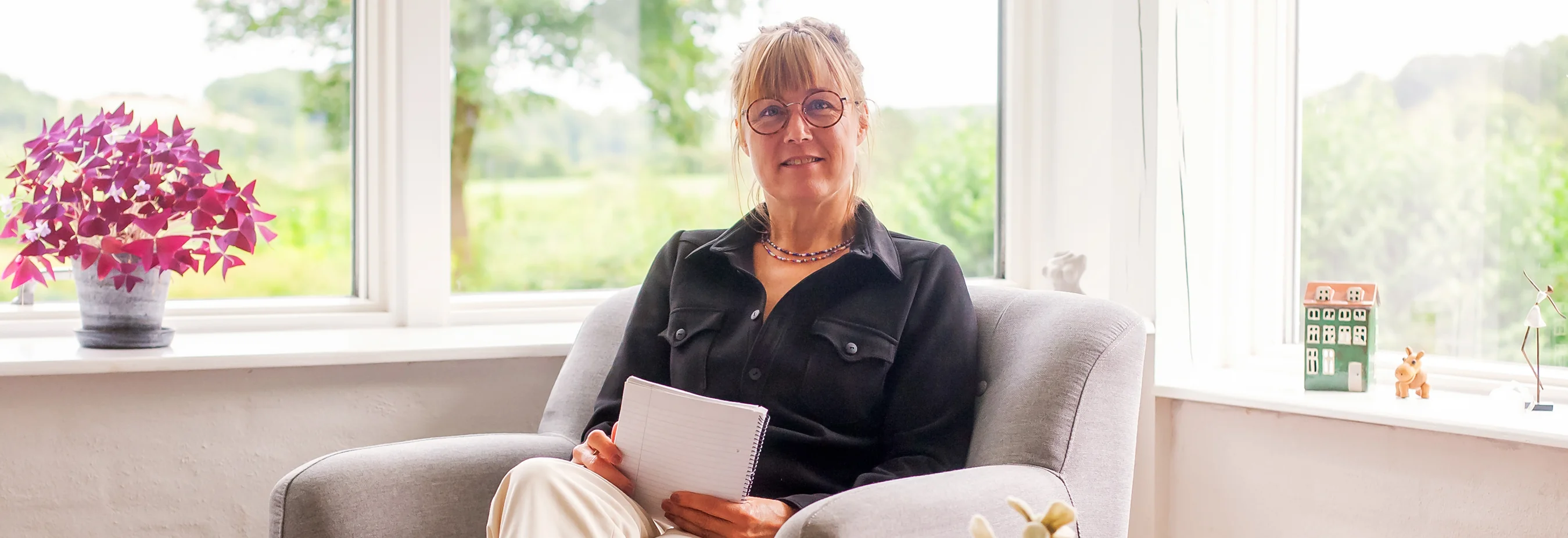 Therapist sitting in chair taking notes